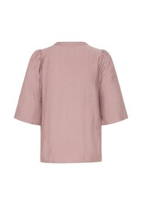 Helles rosa, übergroßes Blusenshirt mit kurzen, puffigen Ärmeln und einem schlichten Ausschnitt. Der Stoff hat eine leicht strukturierte Oberfläche.