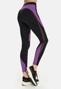 Black and purple leggings feature a geometric design with sheer accents and a high waistband, made from stretchy, breathable material.