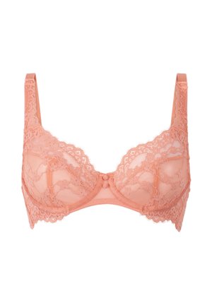 Lace underwire bra in soft peach color, featuring delicate floral patterns, scalloped edges, and a central bow detail. Adjustable straps.