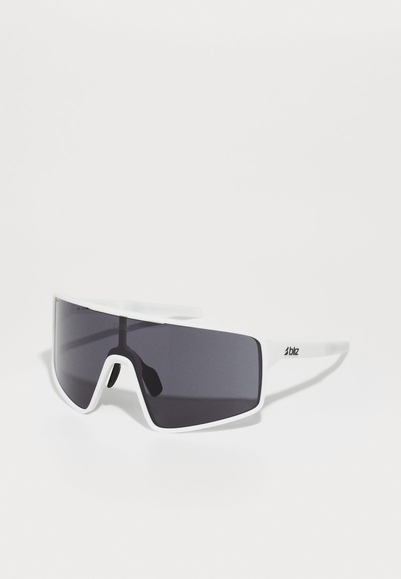 White oversized sunglasses with dark lenses. Made of plastic, featuring a sporty design and a prominent logo on the temple.