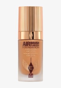 Air Brush Flawless Foundation in a frosted glass bottle. Gold ribbed cap and textured accents. Brown branding details. Sleek and modern design.