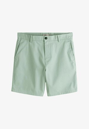 Pantaloncini verde chiaro fino al ginocchio con passanti per cintura, tasche laterali e chiusura con bottone in vita.