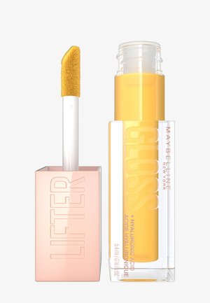 Maybelline Lifter Gloss w przezroczystej tubce o żółtym odcieniu. Różowa kwadratowa nakrętka z wytłoczonym napisem "LIFTER". Zawiera miękki, złoty aplikator.