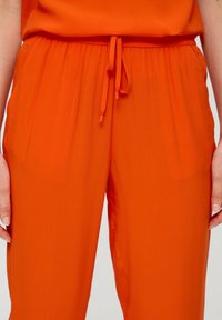 s.Oliver Tracksuit bottoms - dunkelorange