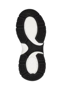 Suola di scarpa sportiva in bianco e nero con gomma testurizzata per la presa, forma contornata e un inserto centrale bianco con dettagli a motivi.