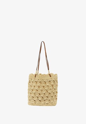 Woven straw tote bag in beige with a textured, open-knit design. Features two brown leather straps and a square shape.