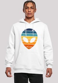 White hoodie featuring a large, distressed alien graphic in gradient stripes of blue, teal, orange, and yellow, with a front pocket.