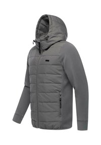 Grå huva jacka med vadderad front, långa ärmar, fickor med blixtlås på sidorna och justerbara huvkordlar. Slät tygtextur.