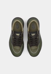 Sneakers featuring a green and brown design, with a mix of suede and mesh materials, round toe, and lace-up front. Notable Vans logo on tongue.
