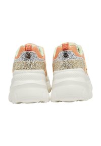 Par chunky sneakers set bagfra med hvide såler, ferskenfarvet stof og sølv- og guldkglitrende detaljer på hælområdet.
