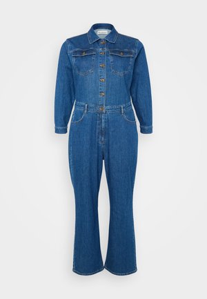 Denim jumpsuit in medium blue, featuring a collared neck, long sleeves, button front, two chest pockets, and flared leg design.