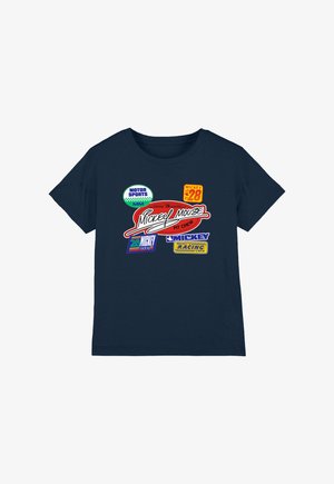 Navy blue t-shirt featuring colorful racing patches with text "Mickey Mouse," "Motor Sports," "Mickey 28," and racing crew logos.
