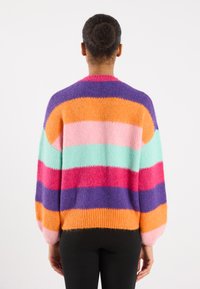Multicolored knitted sweater with broad stripes in pink, orange, teal, purple, and red. Features balloon sleeves and a relaxed fit.