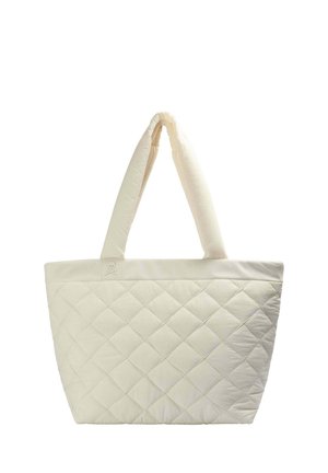 Quilted tote bag in cream, featuring a soft texture, two padded handles, and a logo patch. The diamond pattern decorates the body.