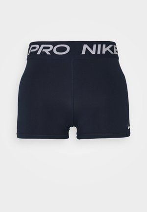 Pantaloni sportivi blu navy con un ampio cinturino nero che presenta il testo "PRO" e "NIKE" in bianco. Tessuto liscio e morbido con una vestibilità aderente.