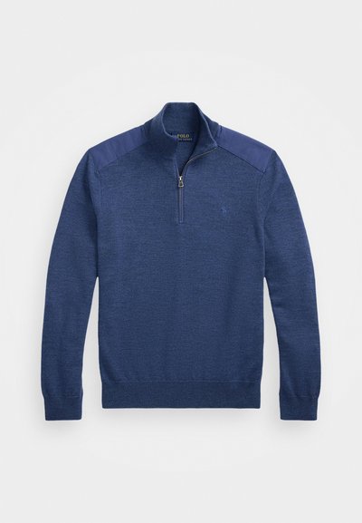 Navy blue knit pullover with a zippered mock collar, textured body, and smooth contrast shoulder panels. Small logo on the chest.