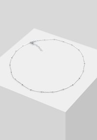 Silver chain necklace with round beads, delicate design, adjustable clasp, featuring a minimalist look and smooth texture.