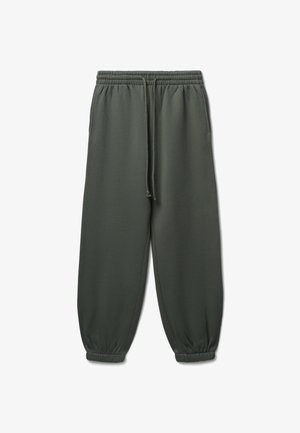 Pantaloni della tuta verdescuro realizzati in tessuto morbido, con vita elasticizzata, cordoncino regolabile, tasche laterali e polsini elastici alla caviglia.