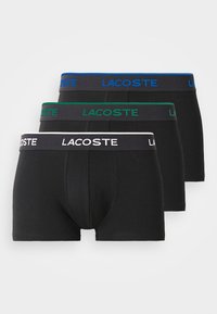 Set van drie zwarte boxershorts met elastische taillebanden. Kleuren zijn zwart, groen en blauw. De stof lijkt zacht met een gladde textuur.