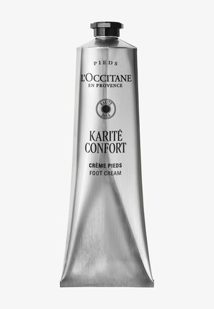 Tube de crème pour les pieds L’Occitane Karité Confort avec bouchon noir, emballage argenté et texte en français et anglais.
