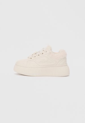 Cream-colored sneaker with a textured platform sole, lace-up design, and plush faux fur collar. Features a smooth suede-like upper material.
