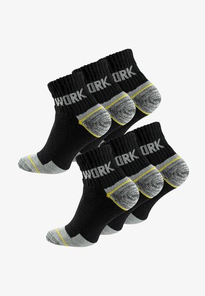 Black work socks with gray toe and heel accents, featuring a ribbed cuff and bold "WORK" text. Includes yellow stripe detail.