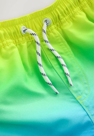 Gröna badshorts med gradient med elastisk midja, vit dragsko och dekorativa sömmar i gult. Slät tygstruktur.