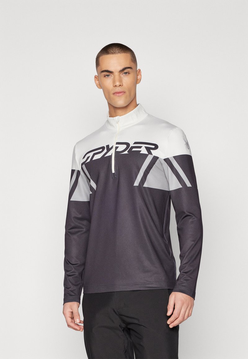 Sportieve lange mouwen top met een halve rits kraag. Gekleurde blokontwerp in zwart, wit en grijs met groot "RYDER" logo aan de voorkant. Glad textuur.