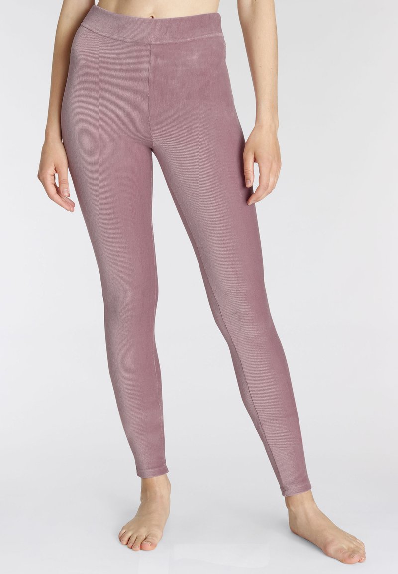 Leggings taille haute de couleur mauve doux, en tissu extensible avec une texture côtelée, présentant une taille lisse et une forme ajustée.