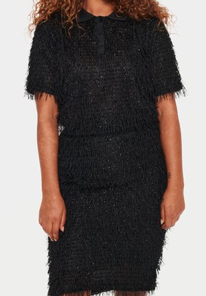 Black textured short-sleeve dress with collar and button placket worn by person with medium brown skin and curly hair.