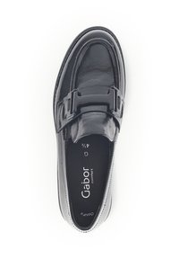 Black patent leather loafer with a smooth finish, featuring a broad strap and hardware accent. Rounded toe and cushioned insole for comfort.