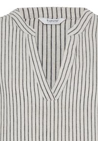 White blouse with vertical black stripes and a V-neck collar, labeled "b.young The Collection" inside the collar.