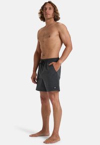 Costumi da bagno da uomo grigi scuri realizzati in tessuto leggero, con vita elastica, tasche laterali e un piccolo logo sulla gamba sinistra.