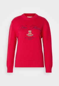 Rød strikket sweater med rund halsudskæring. Har broderet "New Haven" tekst og et crest-logo. Ribbet manchetter og kantdetaljer.