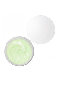 Crème verte dans un pot rond transparent avec une texture lisse et tourbillonnée. Le couvercle est blanc uni et circulaire.