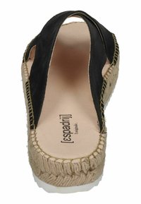 Black canvas espadrille with braided jute sole, featuring a contrasting stitched border, open sides, and a textured interior.
