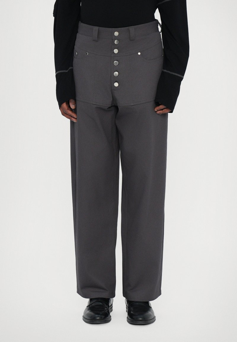 Gray wide-leg pants with a high waist, front patch pockets, and a button fly, made from a sturdy fabric with a smooth texture.