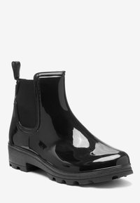 Bottines de pluie noires brillantes avec panneau latéral élastique et tirette, semelle épaisse striée pour une meilleure adhérence.