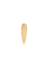 Flytende foundation-svitsj i en lys beige tone med en glatt tekstur, avsmalnet form og blank finish mot en hvit bakgrunn.