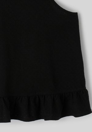 Haut noir sans manches avec ourlet à volants en tissu doux sur un fond clair.