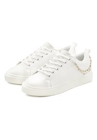 White sneakers made of smooth synthetic material, featuring a round toe, lace-up design, subtle perforations, and a decorative chain accent.