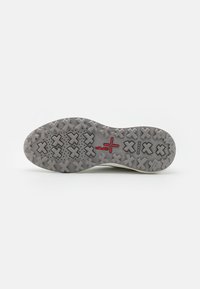 Semelle d'une chaussure grise avec un motif en relief en forme de X, détail croix rouge près du centre, et marquage "GEOX" sur le côté.
