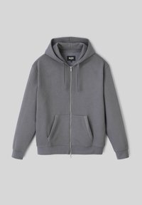 Hoodie gris zippé avec une capuche réglable à cordon, poches avant, poignets côtelés et un tissu doux et texturé. Étiquette de marque à l'intérieur.