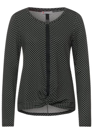 Black long-sleeve shirt with white grid pattern, V-neck, central vertical black strip, and front twist knot hem detail.