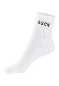 White athletic sock with ribbed cuff, featuring black "LSCN" text. Made from a smooth textile with reinforced toe and heel areas.