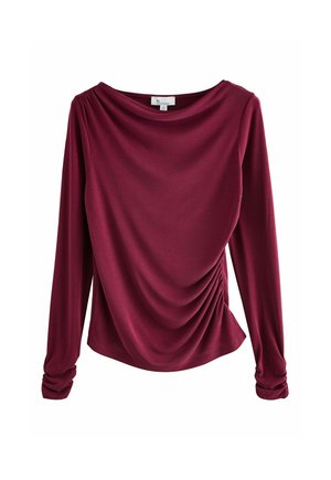 Burgundowa bluzka z długim rękawem, z dekoltem typu cowl, drapowanym przodem i marszczeniem po bokach. Wykonana z miękkiego materiału o gładkiej fakturze.