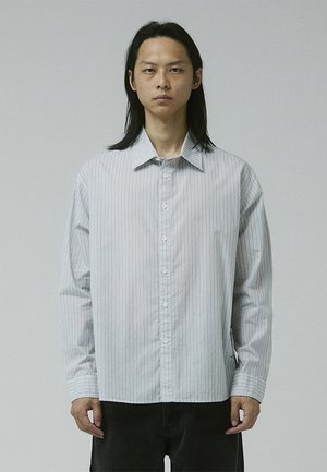 Button-up shirt in light gray with vertical white stripes. Features a classic collar, long sleeves, and a straight-cut hem.