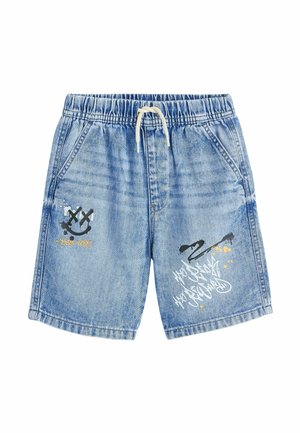 Light blue denim shorts with elastic waist, white drawstring, front pockets, and black graffiti-style smiley face and text designs on legs.