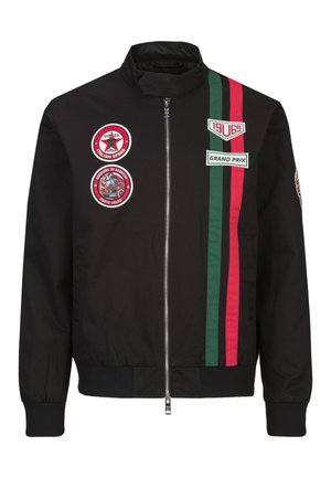 Schwarze Zip-up-Jacke mit grünen und roten Rennstreifen, Aufnäher mit der Aufschrift "Monza Italian Speed", "Grand Prix" und vintage Rennsport-Motiven.