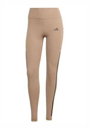 Beiga träningsleggings med hög midja, tillverkade av stretchigt material. Har grå sidränder och en liten svart logotyp på övre låret.